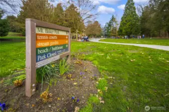 Mt. Baker Park is a gentle ravine boulevard sloping down to Lake Washington, with tennis and pickleball courts, a playground, and a wide tree-lined path leading to the beach. The park's origins trace back to the Olmsted Brothers' 1903 plan for Seattle's park and boulevard system — making it a neighbor that comes with genuine history, just steps from home.