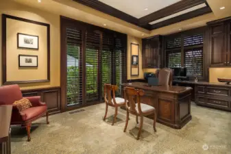 Spacious home office on the main level provides custom built-in walnut bookshelves, file drawers, credenza and French Doors.