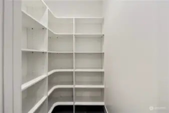 Walk-in pantry with built in shelving.