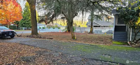 Entrance to the long and wide driveway and Spacious front yard.