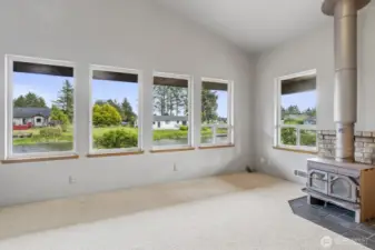 Stunning picture windows frame serene canal views and flood the space with natural light