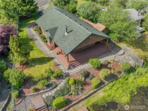 Aerial drone view of the entire property showcases exquisite landscaping and a roof just 7 years old.
