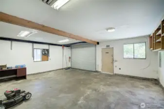 Interior of the multi car shop/garage.  A heavy duty roll-up garage is featured here.