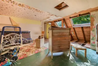 unfinished portion upstairs; church bell visible through attic access in ceiling
