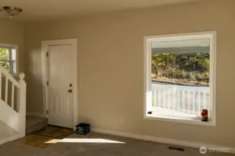 Entry and stairs up. 2 large windows in living room