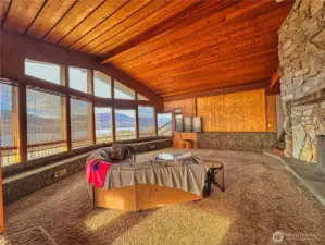 Window seating runs full length of living room window wall