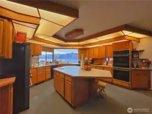 Kitchen with abundant cabinets and counter space with middle kitchen island