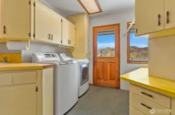 Sizable laundry room with cabinet storage space and exit to back patio