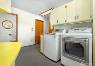 Utility Room with 1/2 guest bath & pantry storage space and exit to attached garage