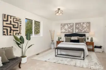 Spacious primary suite easily accommodates a king-size bed and sitting area.