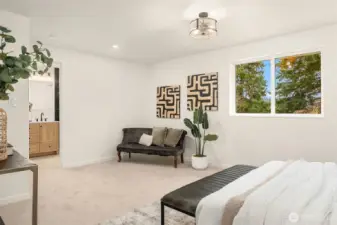 Primary suite overlooks the private backyard and offers space for a sitting area.