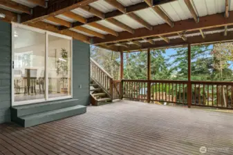Lower level covered deck provides access to upper deck and backyard.