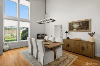 Updated chandelier for the formal dining room. Nearly floor-to-ceiling windows featuring custom Hunter Douglas electric roller shades.