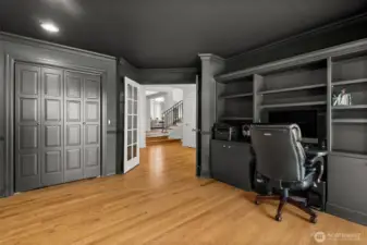 Right next to the kitchen you'll find this color-drenched office with closet and built-ins, could possibly be used as a guest room if desired! There is a sliding door for deck access as well.