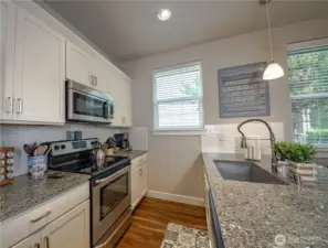 Recessed lighting and pendant lights above the island.