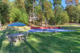 large sunny lawn for entertaining and sports court for basketball and pickleball!