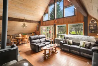 Beautiful hardwood flooring and soaring pine ceilings give this home its warm and cozy feel. Wood stove and oil stove keep it toasty year around.