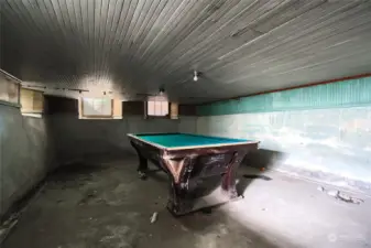 Unfinished basement with billiards table