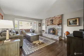 Formal Livingroom with wood burning fireplace and large bay window. All windows are new.