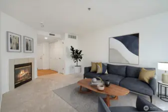 Cozy living area with gas fireplace. Entry with new LVP flooring.  Virtually staged.