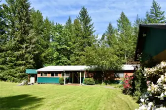 View of side of house with covered patio and mud room.