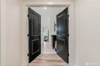 French Doors Lead to the Main Floor Primary Bedroom, Privately Tucked Away from Main Living Space