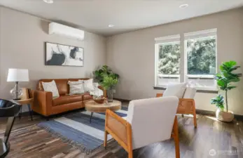 Spacious living room includes a ductless heat pump that keeps the home cool during the hotter summer days!