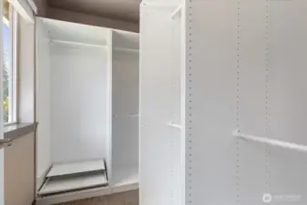 Primary bedroom closet with Ikea organizer system.