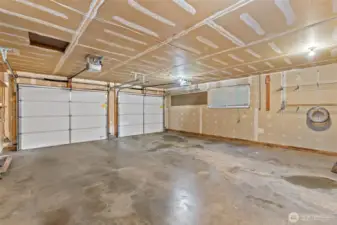 Spacious two-car garage with convenient man-door to the backyard.