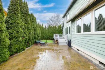 Paver patio, looking toward the deck and putting green.