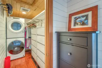 The walk-in closet is complete with built-in storgage and laundry machines.