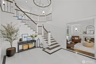 Front entry with marble flooring, custom railing, high end fixtures and lighting and coffered ceilings will leave you speechless.