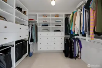Spacious walk-in closet featuring all-new flooring and custom shelving organizers—designed for effortless organization with abundant storage and a clean, polished look.