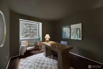 A private and inviting upper-level office overlooking the beautifully landscaped front yard. Warm tones, a large window, and a comfortable layout create a bright, inspiring space for work or quiet retreat.