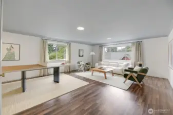 A massive additional living space in the home’s “west wing,” offering incredible flexibility for multi-generational living, guests, or a private retreat. A separate staircase to the left allows for potential independent access, while two additional rooms to the right further expand the possibilities for this versatile wing.