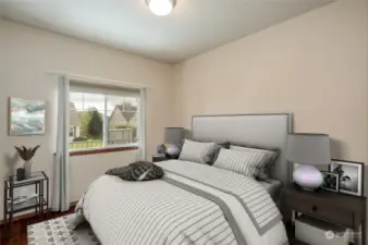 Second of three bedrooms. Wood floors and all window treatments stay with the house. Virtually staged.