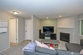 The living area offers a charming wood-burning fireplace, adding warmth and comfort to the space.
