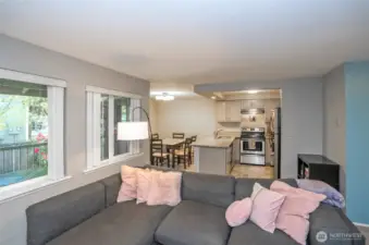 The living area offers a seamless view into the kitchen and dining spaces, highlighting the home’s open-concept layout and effortless flow.
