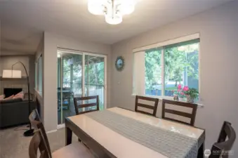 Dining area with a sliding door that opens to the private deck, offering easy access to outdoor relaxation and entertaining.