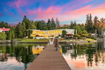 A grand arrival by water – from your private deepwater dock, the S House glows against a painted sky. Two stories of glass capture sunset reflections, while 335’ of manicured shoreline creates a showpiece setting unlike anything else on Wollochet Bay.