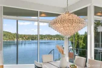 Dine beneath a dazzling crystal chandelier as floor-to-ceiling glass frames serene Wollochet Bay views — every meal here feels like a celebration