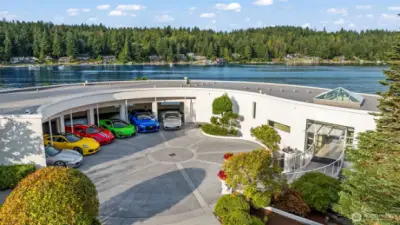 From above, the home’s architectural poetry comes into view — sweeping curves echo the shoreline, creating a perfect harmony between structure and setting.