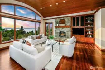 anchored by a cozy rock fireplace and decks flagging each side of the room