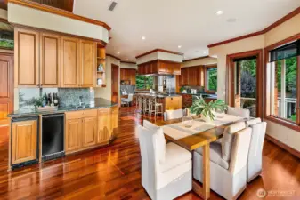 Wet bar, formal dining and kitchen in the background