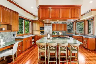 Lovely chef's kitchen with industrial vent that is placed high for ideal hosting around the island
