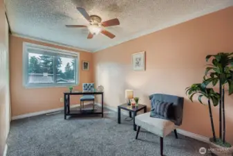 Bedroom #3, located at the NW corner of home, offers carpet, closet with wire shelving, white baseboard trim & ceiling fan