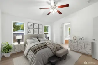 Virtually staged primary bedroom highlighting generous space and vaulted ceilings.