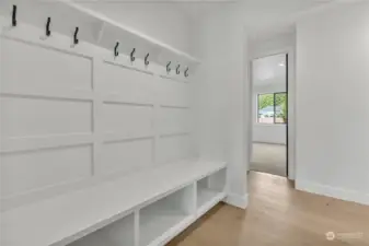 Mudroom entry from the garage with built-in bench, hooks, & cubbies