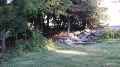 Front yard with pond and tall timber