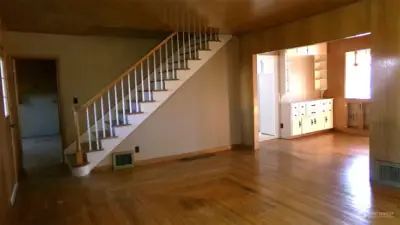 Living Rom stairs, sunroom leading to kitchen. Den/Office to left of stairs